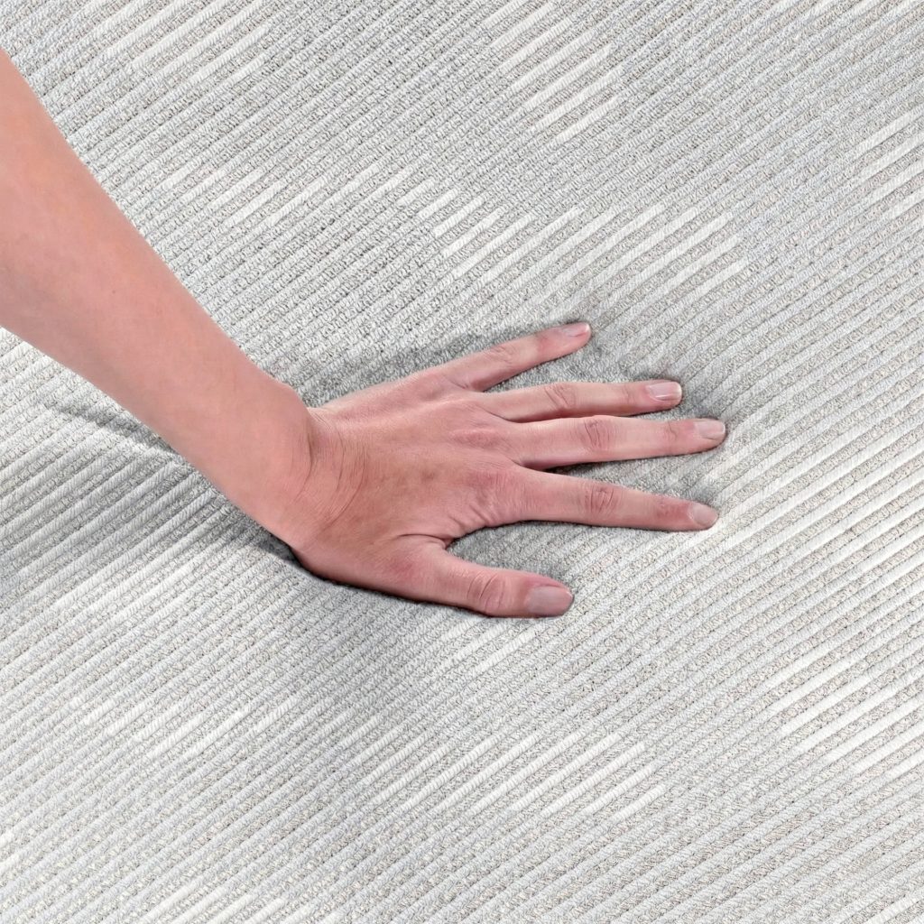Mano presionando el tejido del Pikolin Topper Coolpik