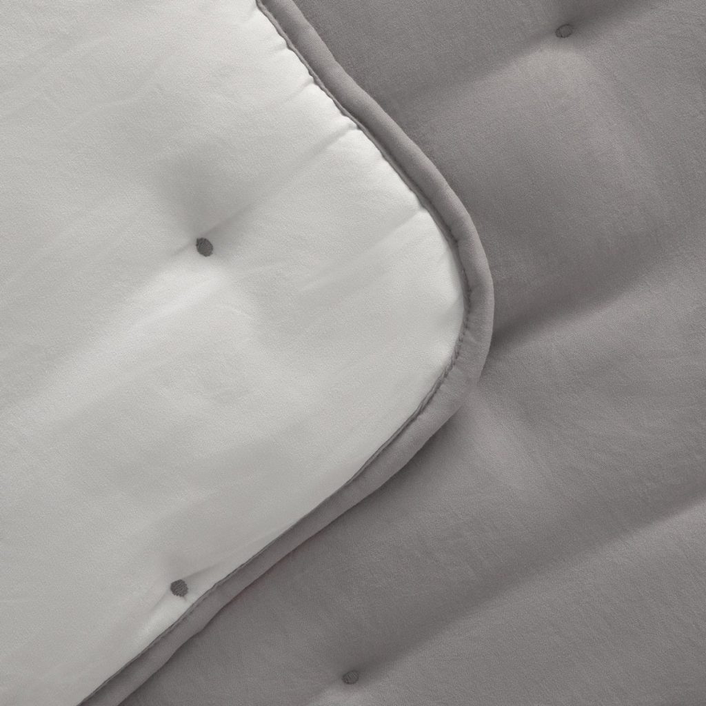 Detalle de los topos y el reverso de contraste del topper Textura Rustcol